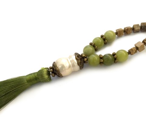close up of freshwater pearl mala necklace tassel